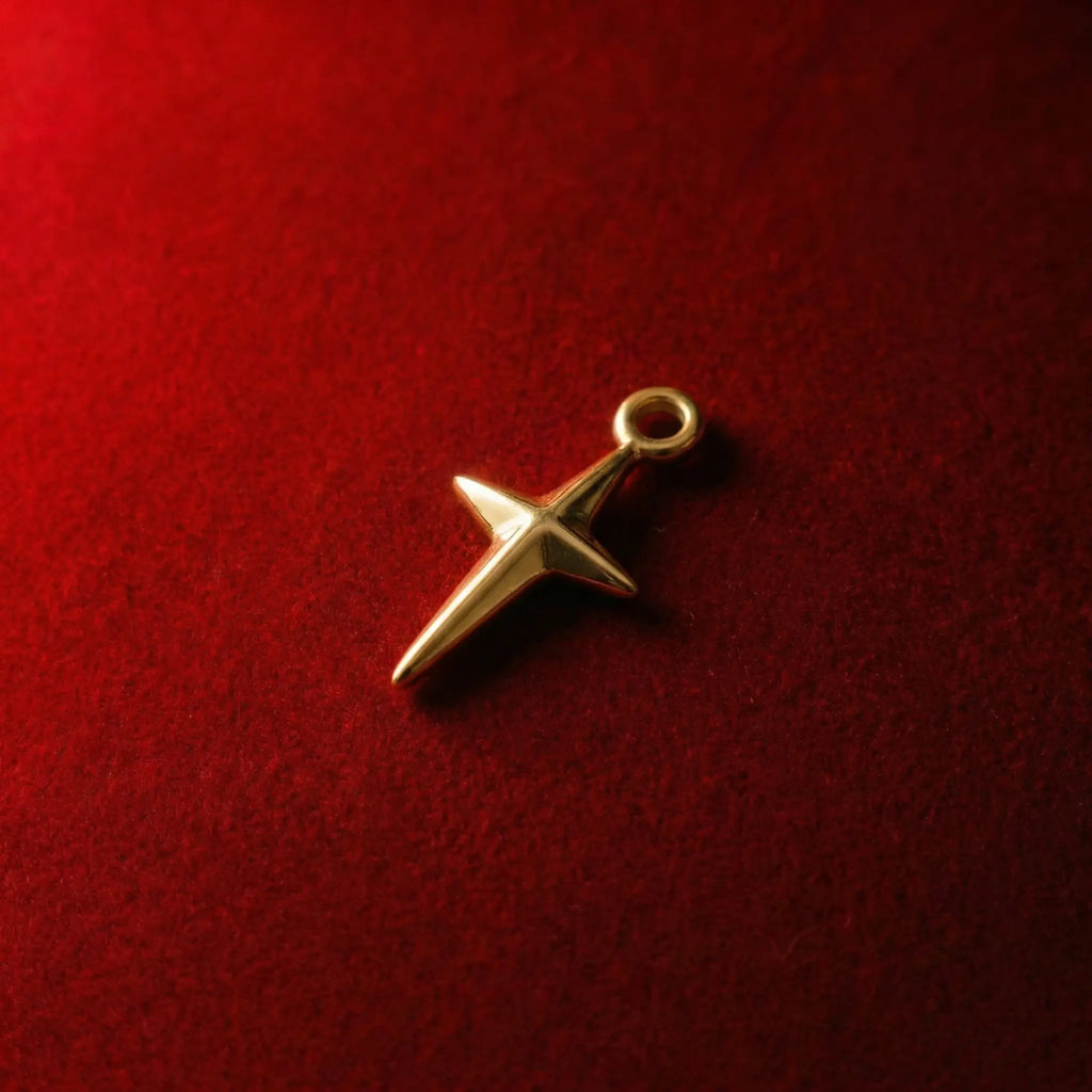 Golden cross pendant featuring a three-dimensional star design