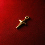 Golden cross pendant featuring a three-dimensional star design
