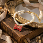 Side view of Rococo style bracelet highlighting the thickness of the gold bone frame and red enamel work