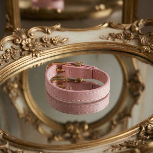 Detail shot focusing on the smooth finish and stitching of the blush pink genuine leather strap