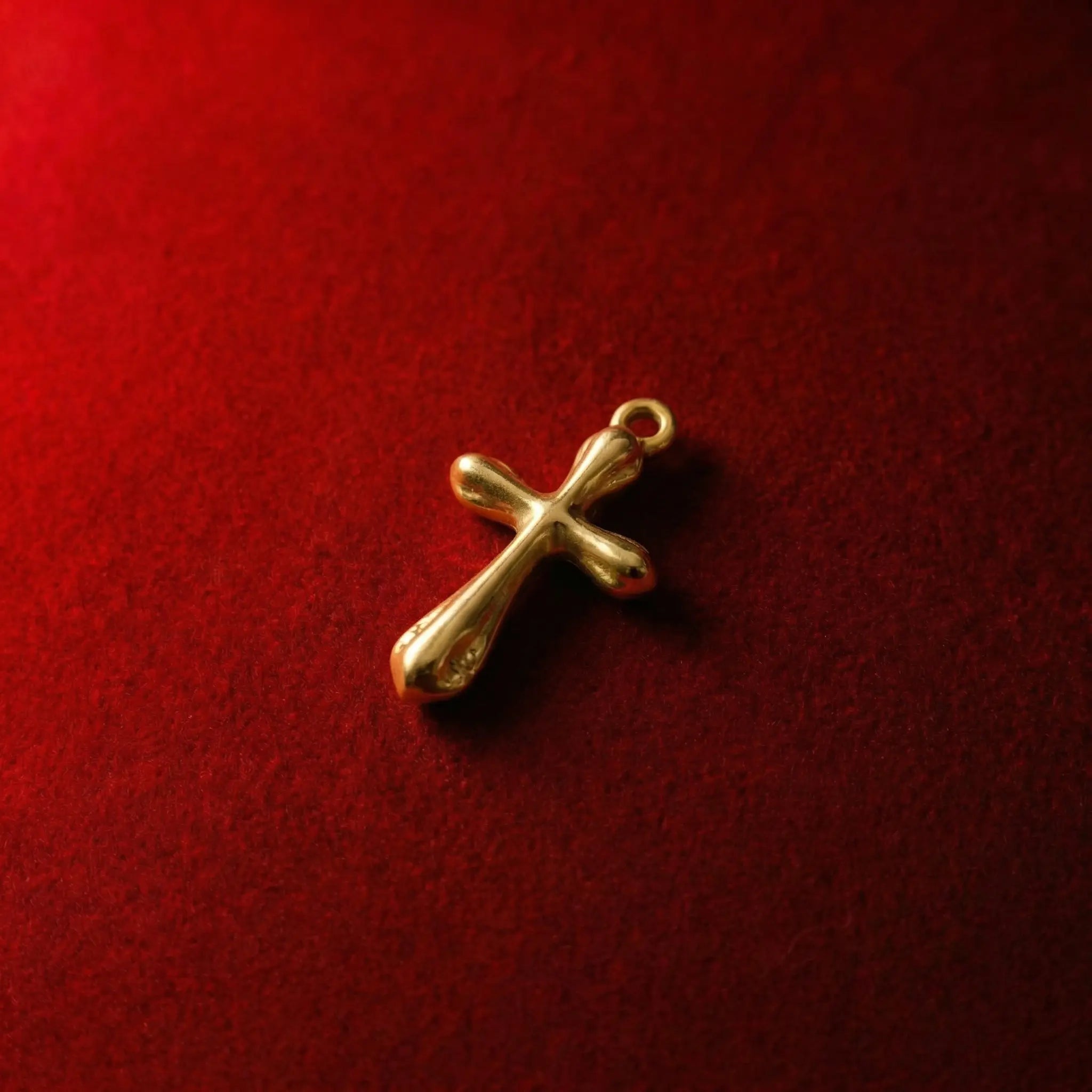 Polished gold cross pendant with rounded edges in a soft-style crucifix design
