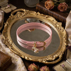 Blush pink genuine leather choker necklace featuring a small gold-plated dog bone pendant charm