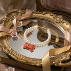 Coquette aesthetic photography: Selviora enamel bone bracelet displayed on vintage vanity mirror