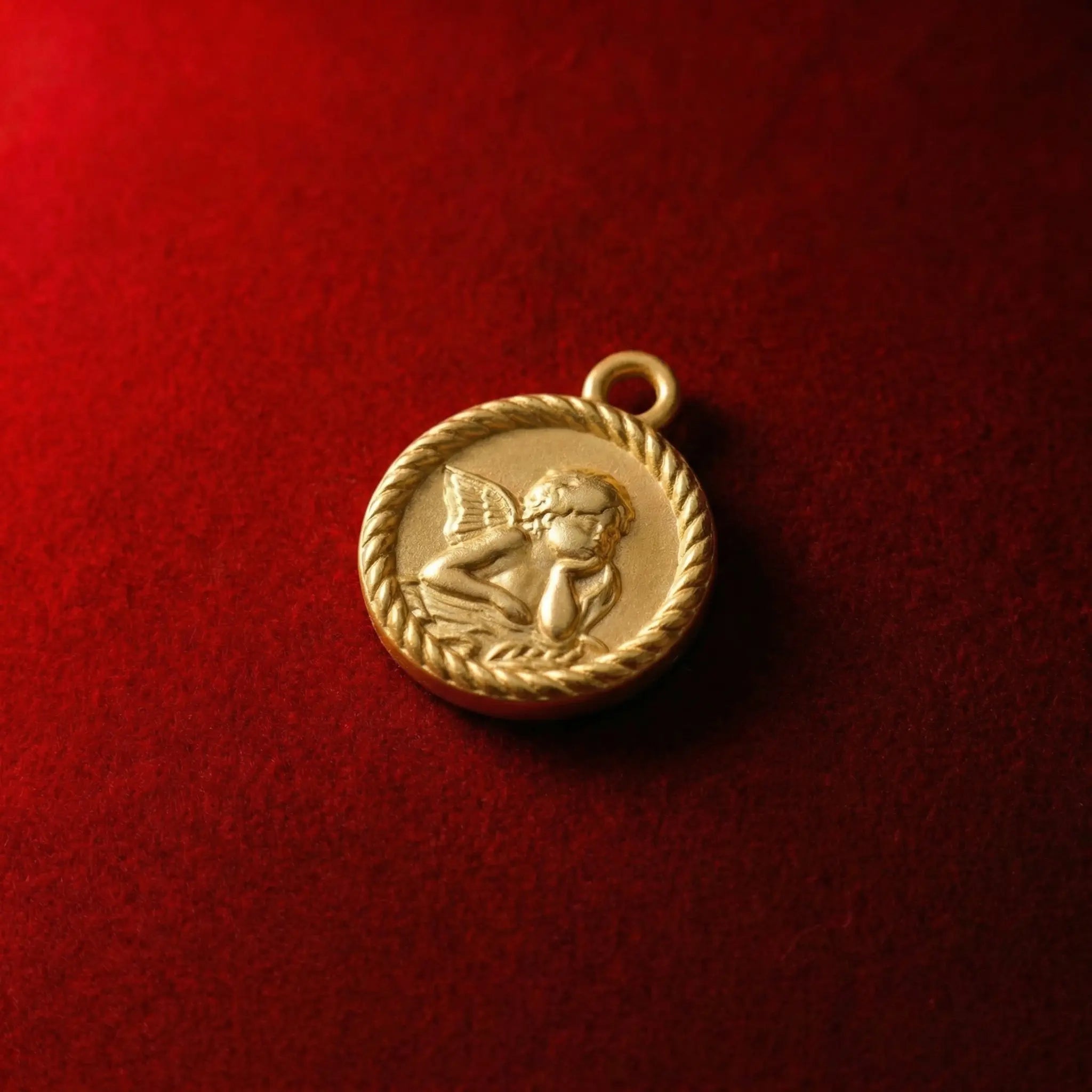 Vintage-style gold coin pendant featuring a Raphael angel relief design
