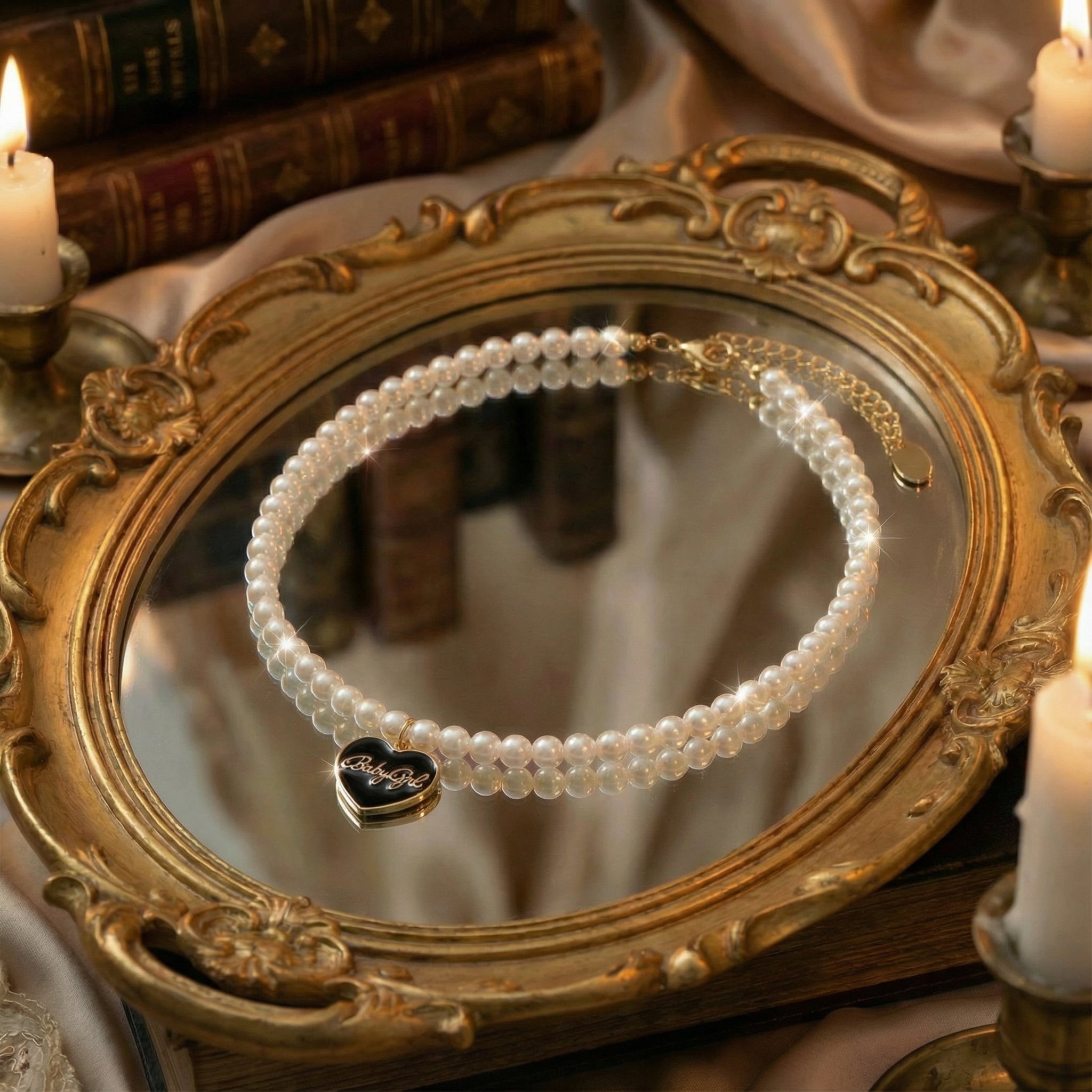 Flat lay shot of freshwater pearl choker necklace featuring a sleek black enamel heart pendant