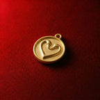 Swan neck heart pendant on a round gold disc Love symbol