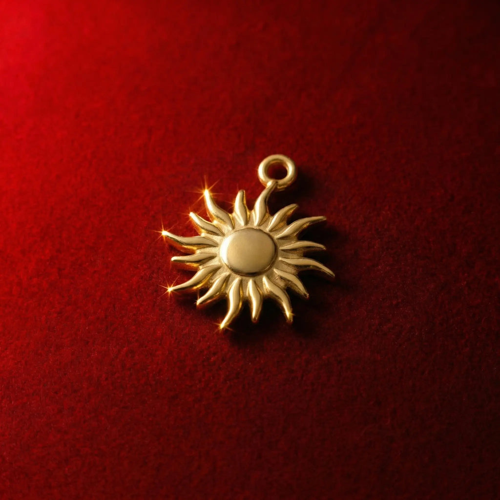 Golden sun pendant with wavy flame-like rays, celestial-inspired design, radiating positive energy