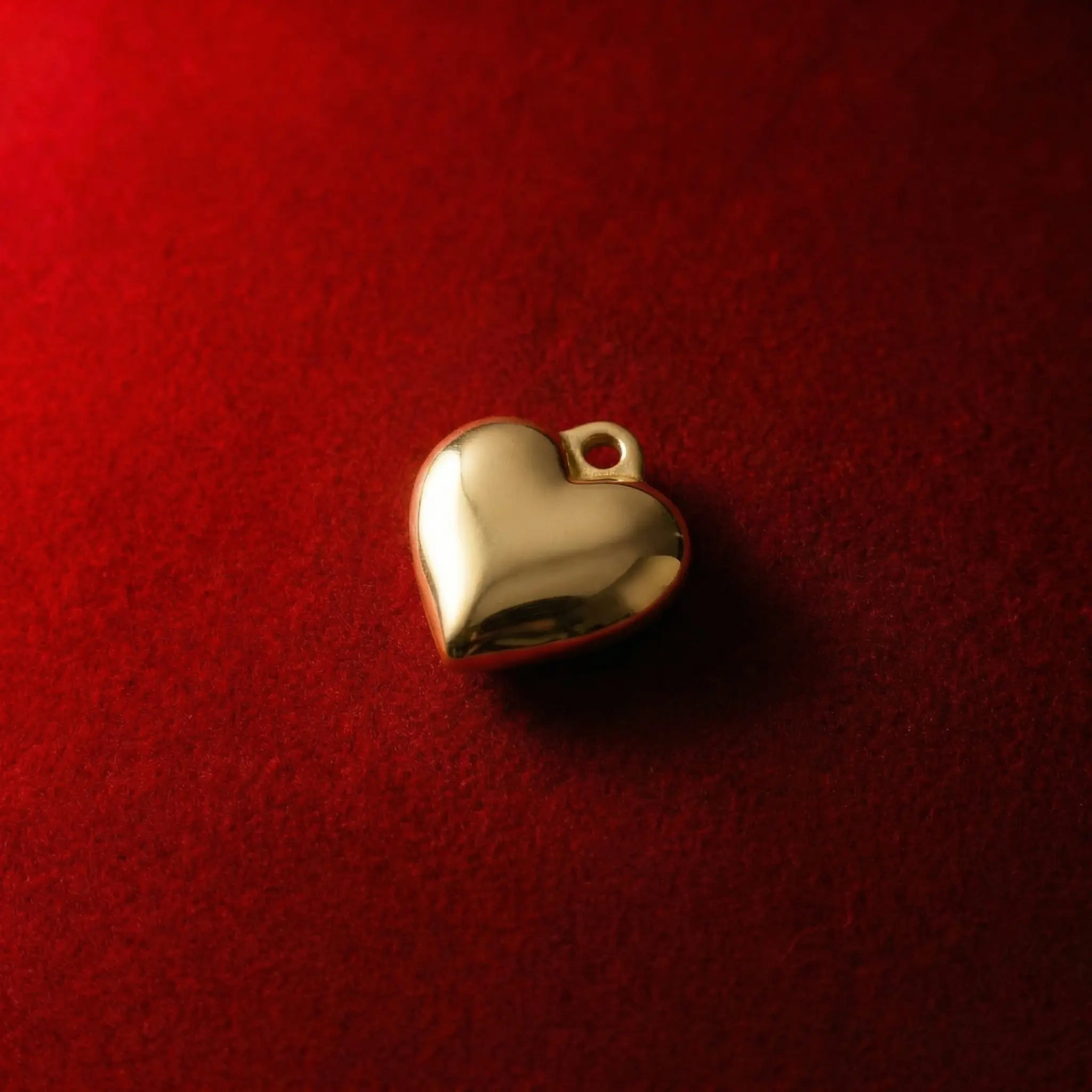 Through-hole gold heart bead charm for minimalist necklaces.